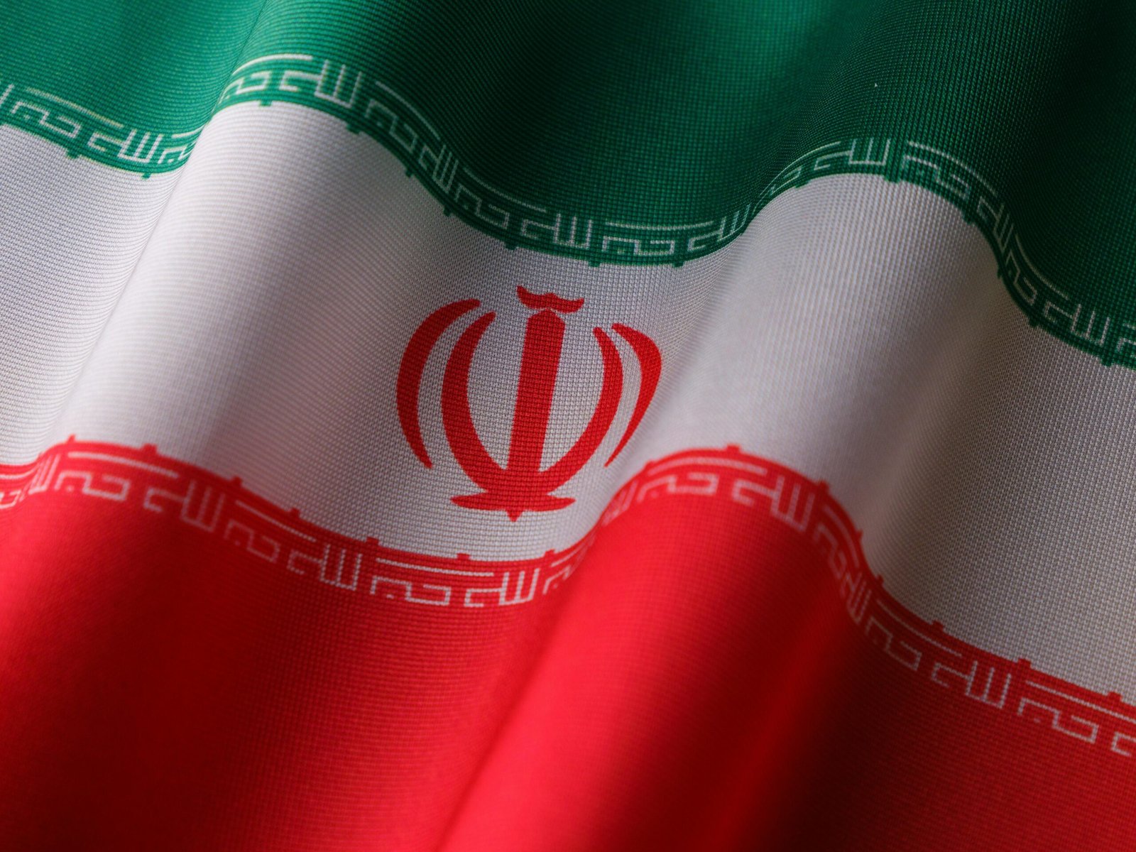 High-quality image of the Iranian national flag waving to symbolize patriotism and national pride.