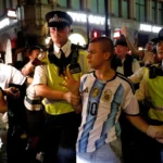 Argentina fan swarmed by England supporters in central London rescued by police