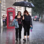 Flash flood warnings for UK as heavy rain batters drought-hit ground