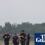 Footage shows French police clashing with people on beach as they try to leave in small boat